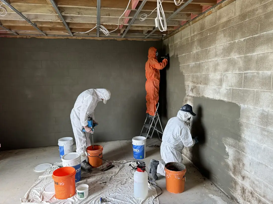 Crystalline waterproofing treatment applied to a concrete surface