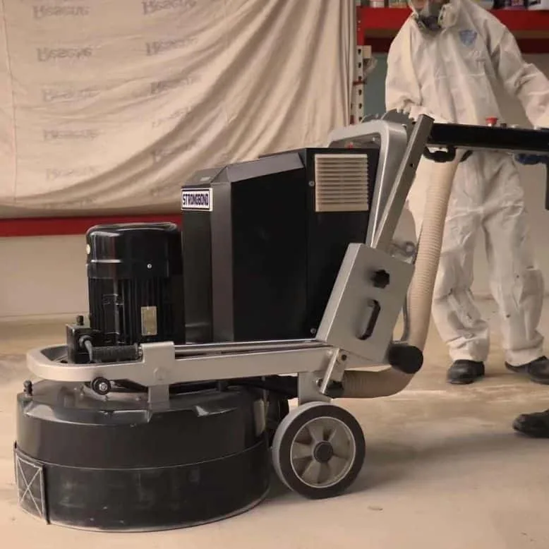 Concrete grinding equipment preparing a floor